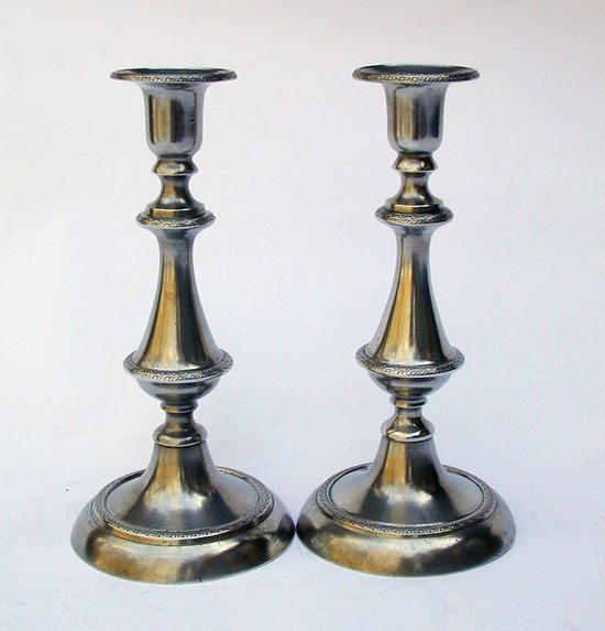 A Pair of Cast Decorated PushUp Pewter Candlesticks