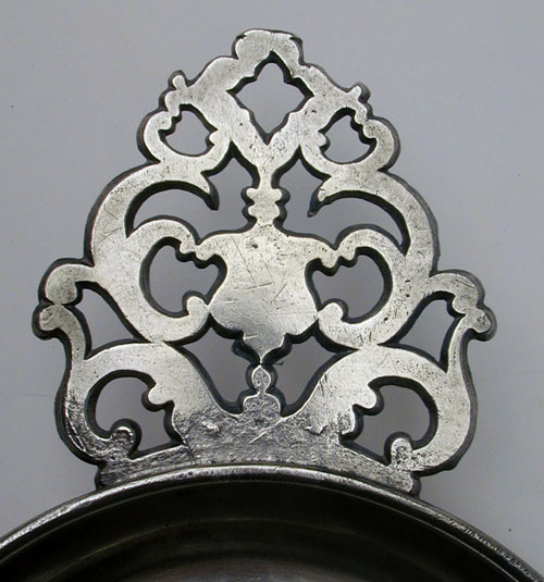 An Unmarked Flower Handle Porringer Attributed  to the Shop of David Melville
