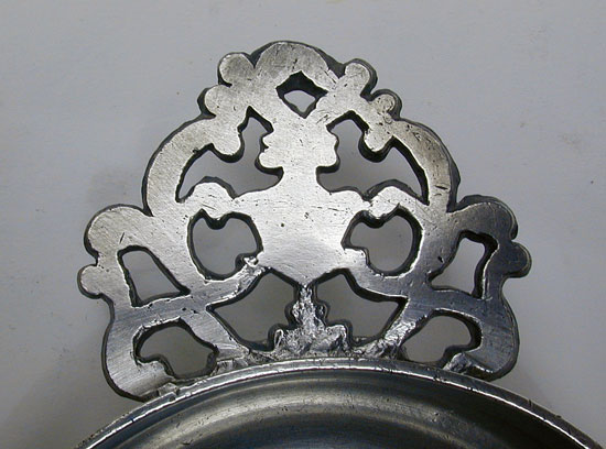 An Unmarked Petite Rhode Island Flower Handle Porringer