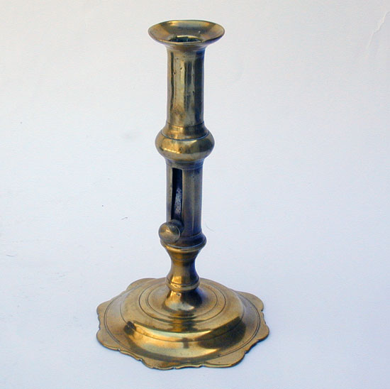 A Mid 18th Century English Push Up Brass Candlestick