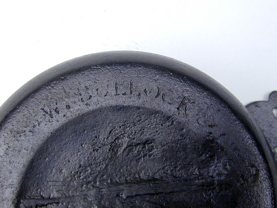 A Cast Iron Porringer byWilliam Bullock & Co 